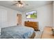 Cozy bedroom with a ceiling fan, wooden dresser and TV showing an exterior view of the home at 2500 Sand Hollow Dr, Lebanon, IN 46052