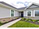 Inviting front entrance with stone accents, manicured flower beds, and a charming walkway at 2500 Sand Hollow Dr, Lebanon, IN 46052