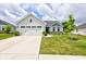 Charming one-story home with a well-manicured lawn, concrete driveway, and attached two-car garage at 2500 Sand Hollow Dr, Lebanon, IN 46052