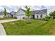 Beautiful home with a green lawn, mature tree, landscaping, and long concrete driveway at 2500 Sand Hollow Dr, Lebanon, IN 46052
