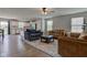 Cozy living room with comfortable seating, ceiling fan, and seamless flow into the kitchen at 2500 Sand Hollow Dr, Lebanon, IN 46052