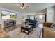 Inviting open-concept living room with a large TV, hardwood floors, and a view of the kitchen at 2500 Sand Hollow Dr, Lebanon, IN 46052