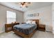 This main bedroom features a ceiling fan, two side tables, and a wooden bedframe at 2500 Sand Hollow Dr, Lebanon, IN 46052