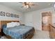 This main bedroom features a ceiling fan, and a wooden bedframe with white pillows at 2500 Sand Hollow Dr, Lebanon, IN 46052