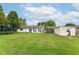 Expansive backyard with lush green grass, a trampoline, shed, and a charming home exterior at 26858 State Road 19, Arcadia, IN 46030