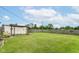 Large, grassy backyard featuring a shed, wooden fence, and plenty of space for outdoor activities at 26858 State Road 19, Arcadia, IN 46030