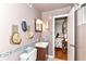 Compact half bathroom with decorative mirror and adjacent closet at 26858 State Road 19, Arcadia, IN 46030