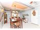 Charming dining area with a dark wood table, decorative accents, and convenient access to the entrance and kitchen at 26858 State Road 19, Arcadia, IN 46030
