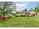 Charming brick home with well-maintained lawn, mature landscaping, and inviting curb appeal at 26858 State Road 19, Arcadia, IN 46030