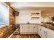 A modern bar area featuring white subway tile, gray cabinetry, wood paneled wall, and a beverage refrigerator at 2783 W High Grove Cir, Zionsville, IN 46077
