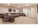 A finished basement showcasing a large sectional sofa, carpeted floors, and recessed lighting at 2783 W High Grove Cir, Zionsville, IN 46077