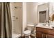 Cozy bathroom with a shower, dark vanity, and ceramic toilet at 2783 W High Grove Cir, Zionsville, IN 46077