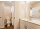 Bathroom featuring a toilet, shower with curtain, and single sink vanity with white marble countertop at 2783 W High Grove Cir, Zionsville, IN 46077