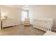 Bright Bedroom featuring a crib, rocker, dresser and a chandelier hanging from the ceiling at 2783 W High Grove Cir, Zionsville, IN 46077