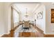 Elegant dining room featuring hardwood floors, chandelier, and natural light at 2783 W High Grove Cir, Zionsville, IN 46077