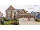 Stunning brick home featuring an attached two-car garage and professionally landscaped yard at 2783 W High Grove Cir, Zionsville, IN 46077