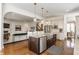 Open concept kitchen with island, stainless appliances, and seamless transition to the living area at 2783 W High Grove Cir, Zionsville, IN 46077