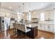 Bright, open kitchen with a center island, modern appliances, and hardwood floors at 2783 W High Grove Cir, Zionsville, IN 46077