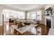 Open-concept living room with fireplace seamlessly flows into a gourmet kitchen and dining area at 2783 W High Grove Cir, Zionsville, IN 46077
