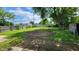 Spacious backyard featuring a large grassy area, mature trees, and a partial circular dirt patch at 2807 Carla Ct, Indianapolis, IN 46219