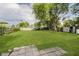 Large backyard with lush green lawn, mature trees, and partial fencing at 2807 Carla Ct, Indianapolis, IN 46219