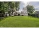 Spacious backyard with green grass, trees, shed, and view of house at 2807 Carla Ct, Indianapolis, IN 46219