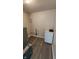 Functional basement space with modern flooring, utility connections, and a white storage cabinet at 2807 Carla Ct, Indianapolis, IN 46219