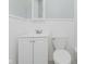 Bathroom featuring white vanity, toilet, and beadboard paneling at 2807 Carla Ct, Indianapolis, IN 46219