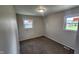 Bright bedroom with neutral paint, carpet flooring, baseboard trim and two windows for natural light at 2807 Carla Ct, Indianapolis, IN 46219