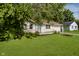 Front exterior with well-maintained lawn and mature trees at 2807 Carla Ct, Indianapolis, IN 46219