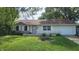Charming single-story home with a well-maintained lawn and flowerbeds in a peaceful residential neighborhood at 2807 Carla Ct, Indianapolis, IN 46219