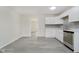 Bright kitchen featuring white cabinets, stainless steel appliances, and gray tile backsplash at 2807 Carla Ct, Indianapolis, IN 46219