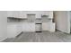 Updated kitchen with white cabinets, stainless steel appliances and a grey tiled backsplash at 2807 Carla Ct, Indianapolis, IN 46219