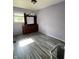 Bedroom featuring gray floors, lavender walls, and a wooden dresser at 2826 Falcon Dr, Indianapolis, IN 46222