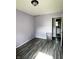 Bedroom with gray wood-look floors, light lavender walls, and ample natural light at 2826 Falcon Dr, Indianapolis, IN 46222