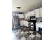 Functional kitchen featuring stainless steel appliances and checkered flooring at 2826 Falcon Dr, Indianapolis, IN 46222