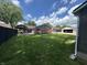 Spacious back yard featuring a pergola, lush lawn, brick accents, and multiple garage spaces at 2845 12Th St, Columbus, IN 47201
