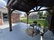 Backyard patio with a covered pergola, seating area, and view of the well-maintained lawn and shed at 2845 12Th St, Columbus, IN 47201