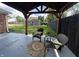 Cozy backyard patio under a pergola, furnished with wicker chairs and a view of the lawn and shed at 2845 12Th St, Columbus, IN 47201