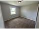 Bedroom featuring carpet floors, painted walls, window and white trim at 2845 12Th St, Columbus, IN 47201