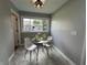 Dining area with natural light, view to backyard, tile flooring, and modern table set for two at 2845 12Th St, Columbus, IN 47201