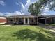 Charming brick home featuring a well-manicured lawn and cozy front porch seating area at 2845 12Th St, Columbus, IN 47201