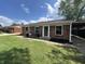 Charming brick home featuring a well-manicured lawn and cozy front porch seating area at 2845 12Th St, Columbus, IN 47201