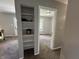 Hallway includes a decorative shelving nook, leading to another room with light walls and a window at 2845 12Th St, Columbus, IN 47201