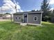 Exterior view of a backyard shed with gray siding, windows, and a well-maintained lawn at 2845 12Th St, Columbus, IN 47201