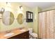 Bathroom with a double sink vanity, decorative mirrors, and a shower with curtain at 3067 Stilton Dr, Cicero, IN 46034
