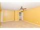 Yellow-walled bedroom with neutral carpeting, ceiling fan, and doorway leading to other rooms at 3067 Stilton Dr, Cicero, IN 46034
