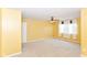 Spacious bedroom with neutral carpet, yellow walls, ceiling fan, and sunlit windows at 3067 Stilton Dr, Cicero, IN 46034