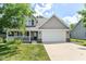 Charming two-story home with a welcoming front porch and attached two-car garage at 3067 Stilton Dr, Cicero, IN 46034