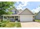 Charming two-story home with a welcoming front porch and attached two-car garage at 3067 Stilton Dr, Cicero, IN 46034